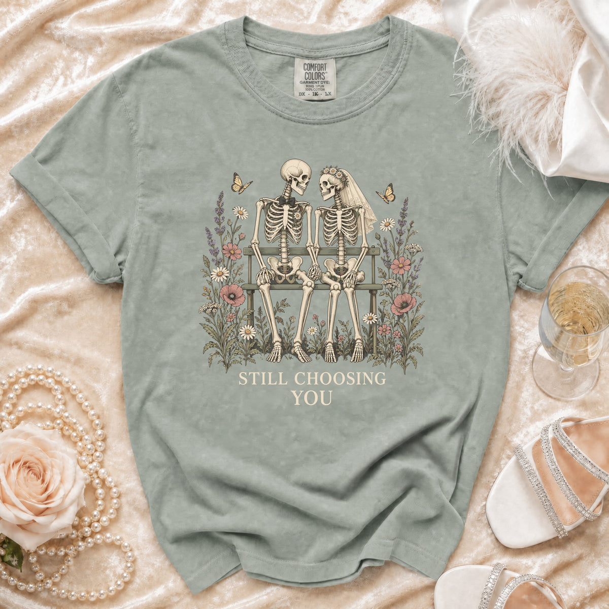 T-shirt with skeletons, flowers, butterflies, and text "STILL CHOOSING YOU."