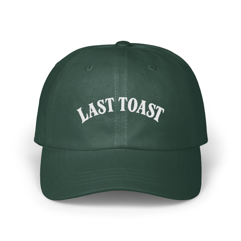 Green baseball cap with white embroidered text "LAST TOAST".