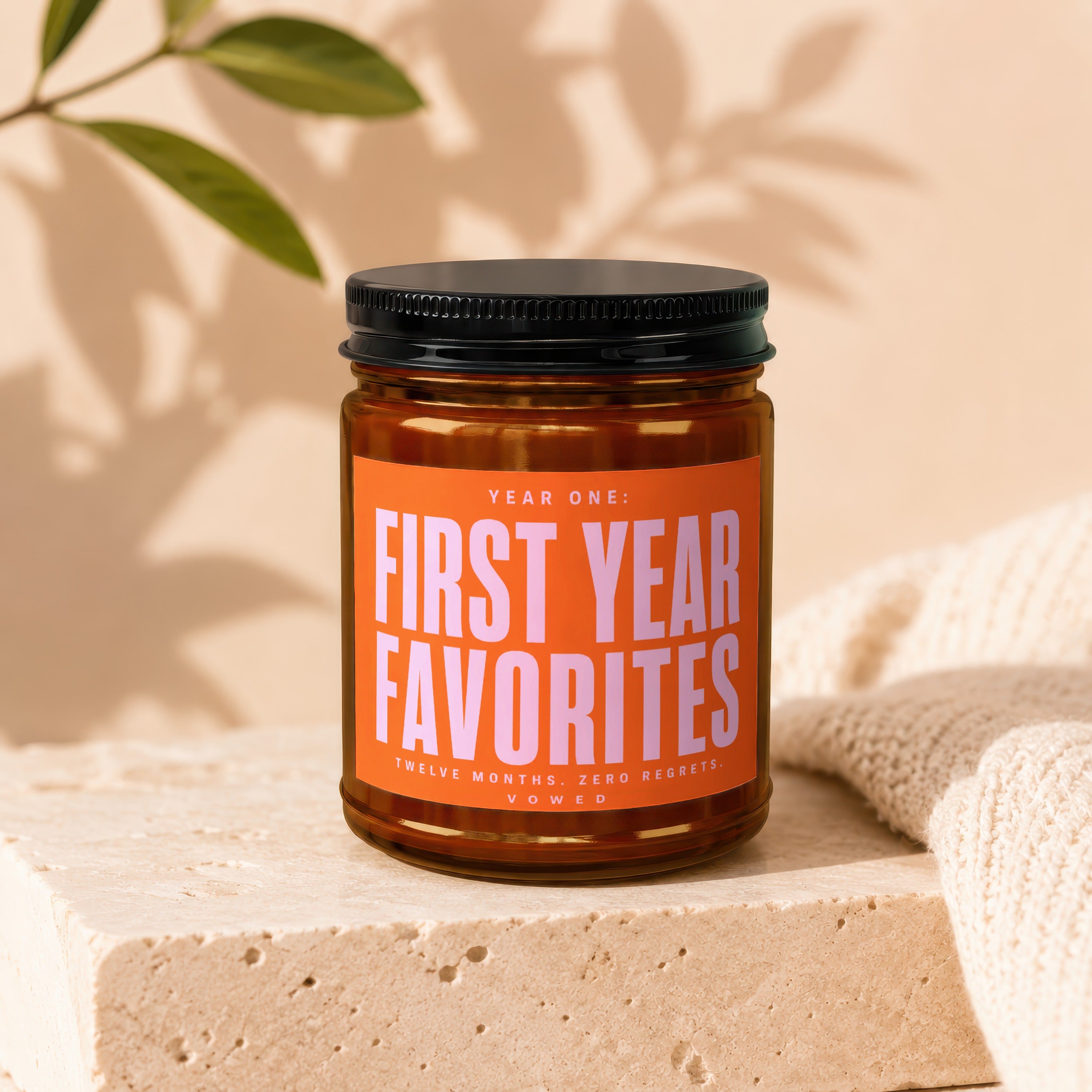 Amber jar candle labeled "Year One: First Year Favorites. Twelve Months. Zero Regrets. Vowed."