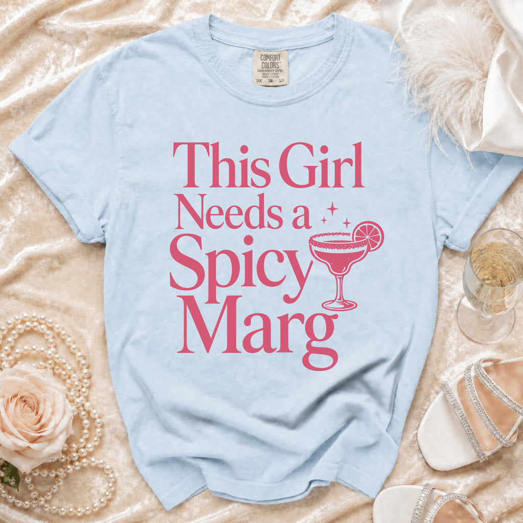 Light blue t-shirt with pink text "This Girl Needs a Spicy Marg" and margarita graphic.