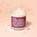 Candle with text "The gays are getting married vowed" surrounded by petals.