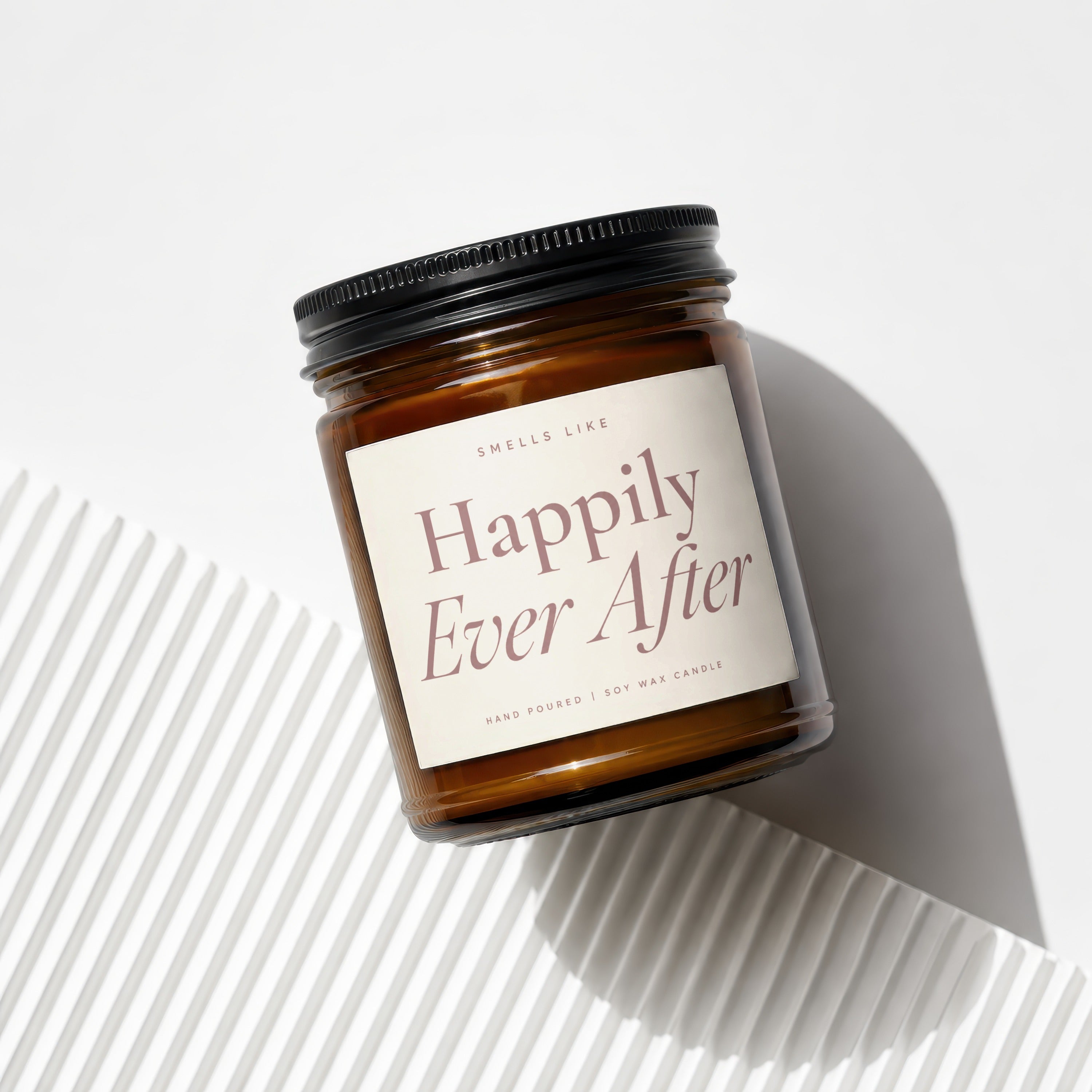 Amber jar candle with black lid labeled "Happily Ever After", from Smells Like.