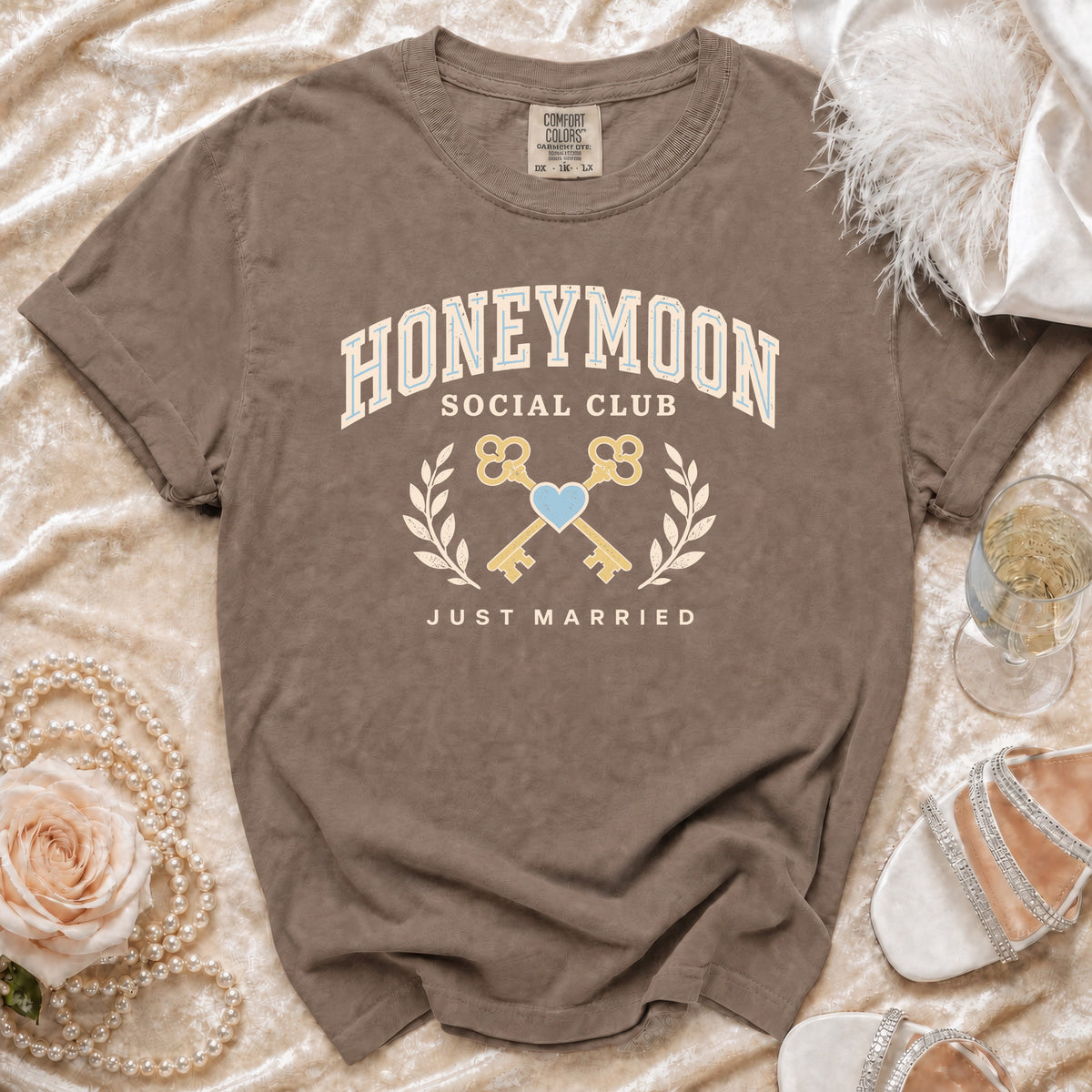 Brown t-shirt with "Honeymoon Social Club Just Married" text, keys, and heart graphic.