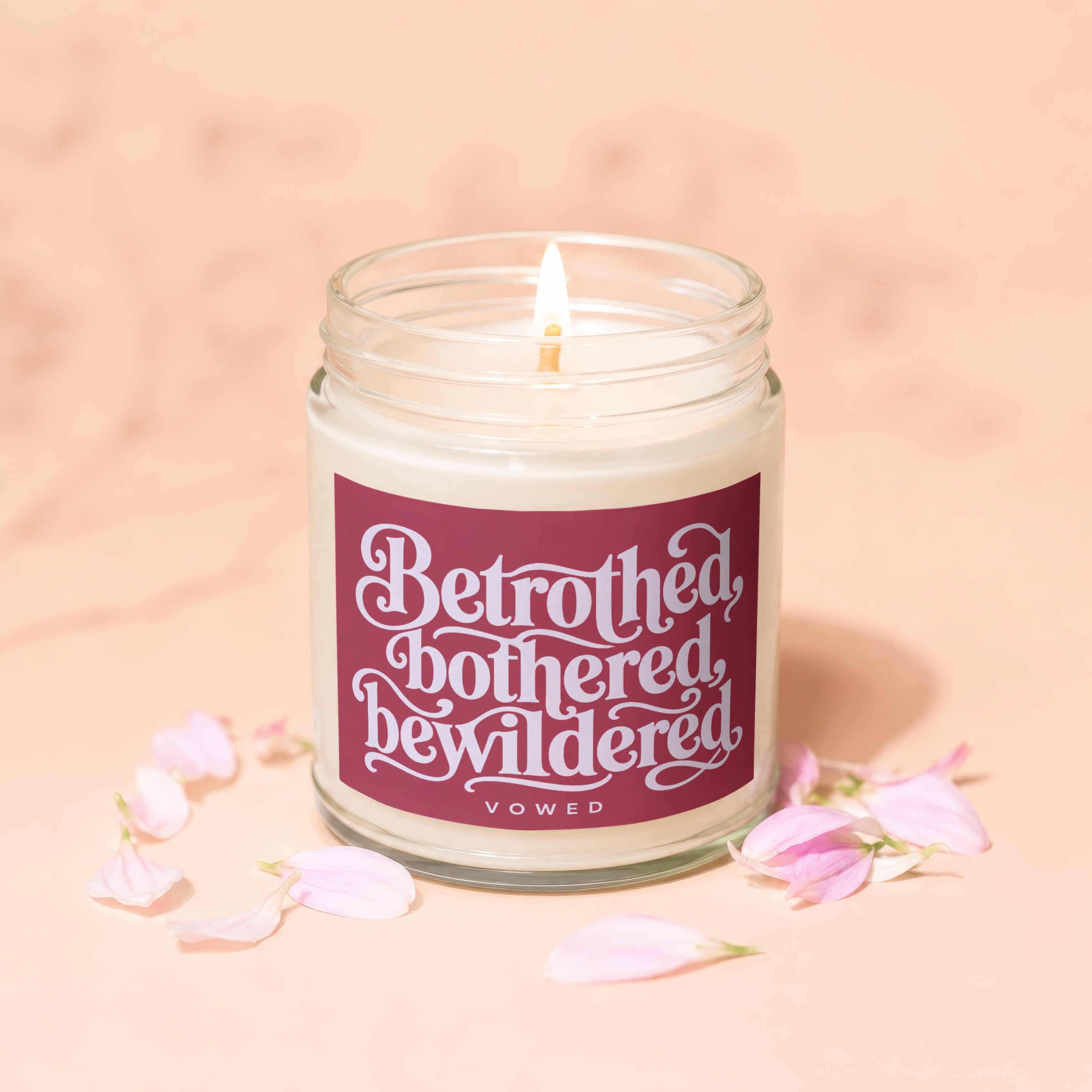 Jar candle with label reading "Betrothed, bothered, bewildered, VOWED".