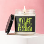 Candle with black lid titled "My Last Night of Freedom" on a pink background.