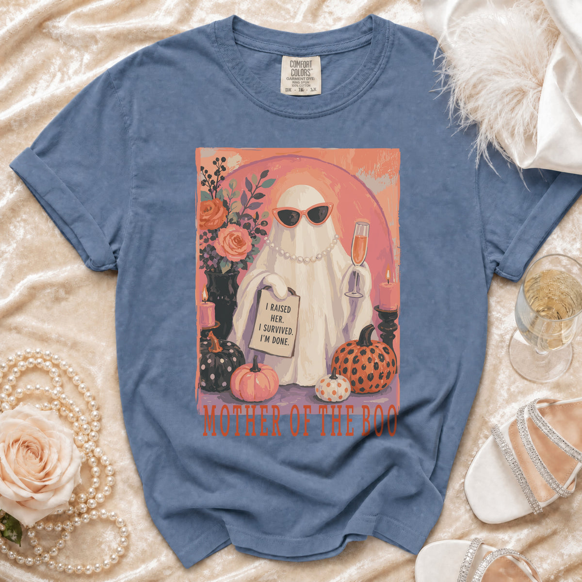 Blue t-shirt with graphic of a ghost saying "I raised her. I survived. I'm done." Mother of the Boo.