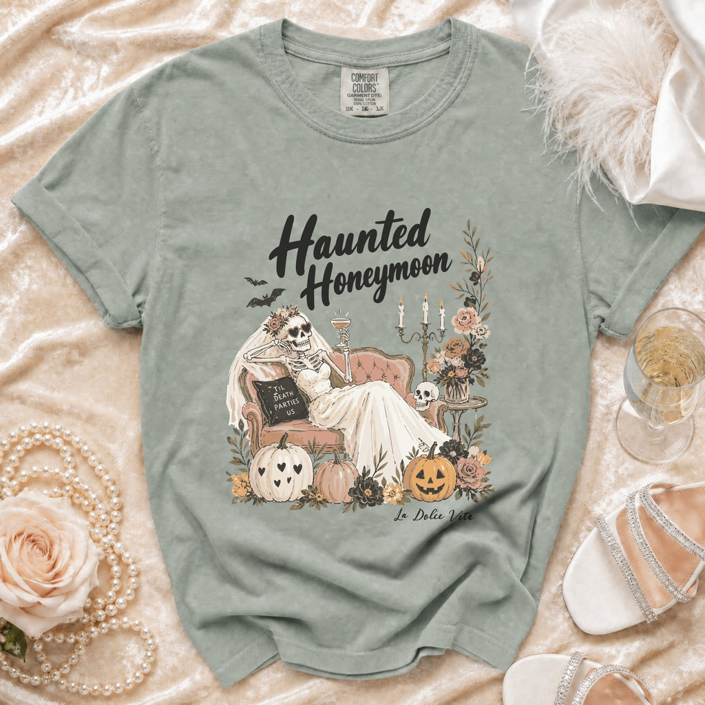 Skeleton bride on couch with text "Haunted Honeymoon" and "Til Death Parties Us".