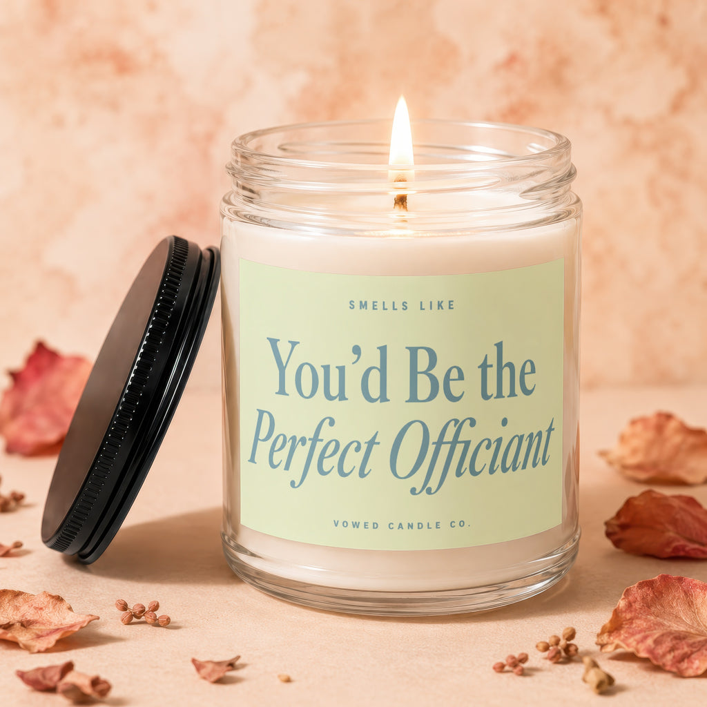 Glass candle with lit wick and "You'd Be the Perfect Officiant" text.