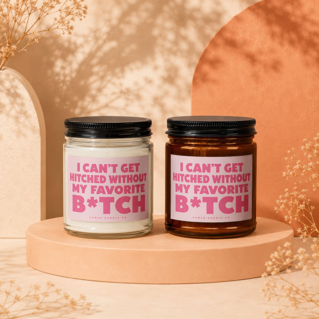 Two candles with pink labels reading "I can't get hitched without my favorite B*tch".