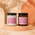 Two candles with pink labels reading "I can't get hitched without my favorite B*tch".