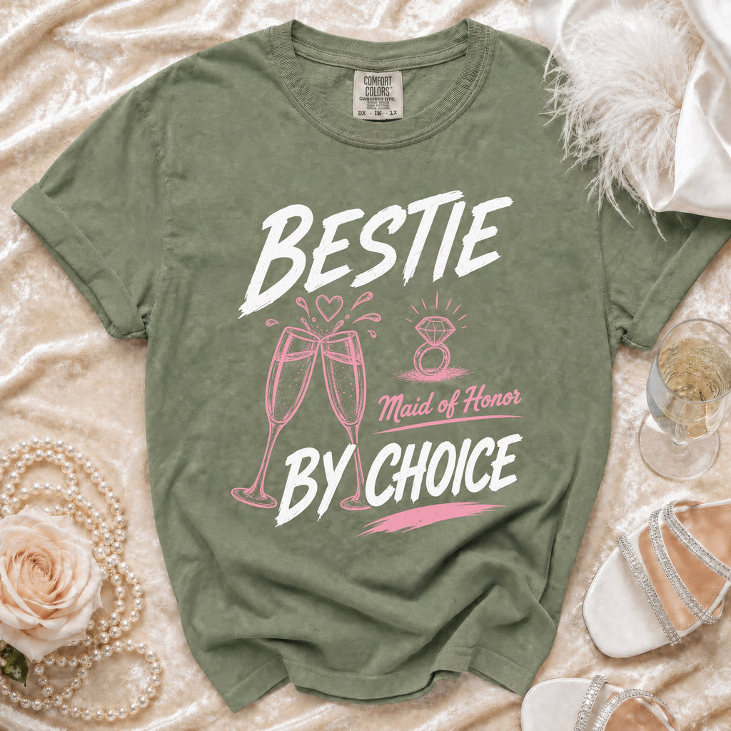Sage green t-shirt with "BESTIE Maid of Honor BY CHOICE" graphic.