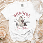 White t-shirt with "Seaside Bride Club" graphic featuring a ghost bride and bats.