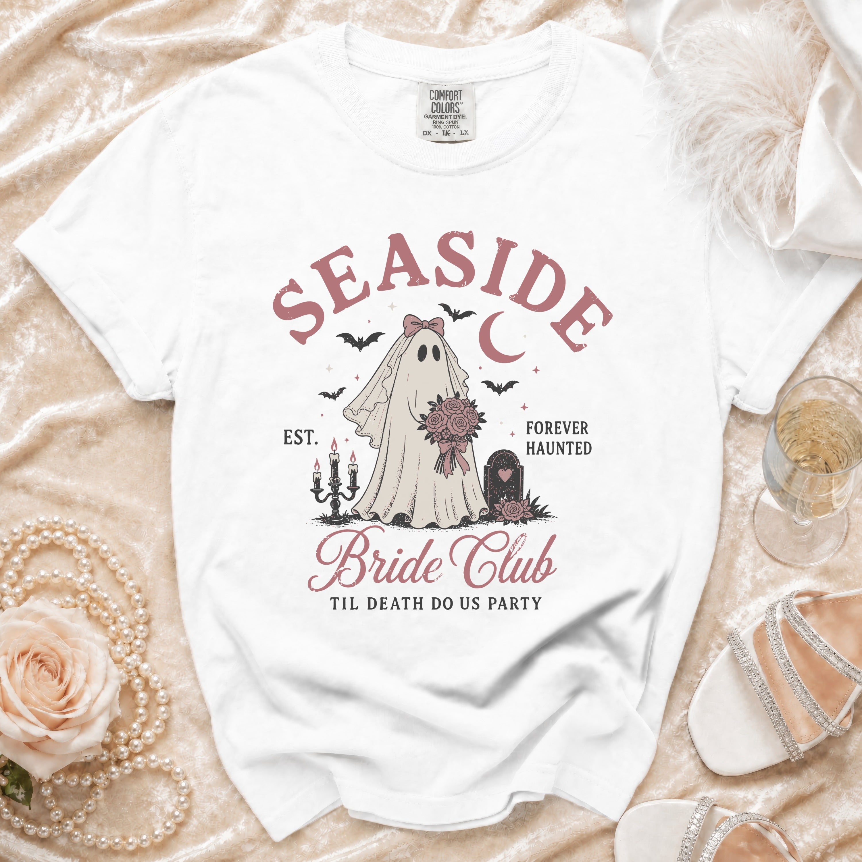 White t-shirt with "Seaside Bride Club" graphic featuring a ghost bride and bats.