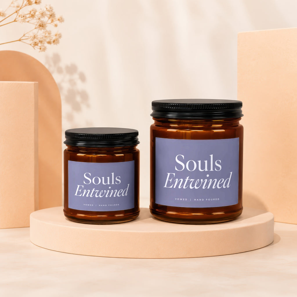 Two 'Souls Entwined Vowed Hand Poured' candles on pedestals.