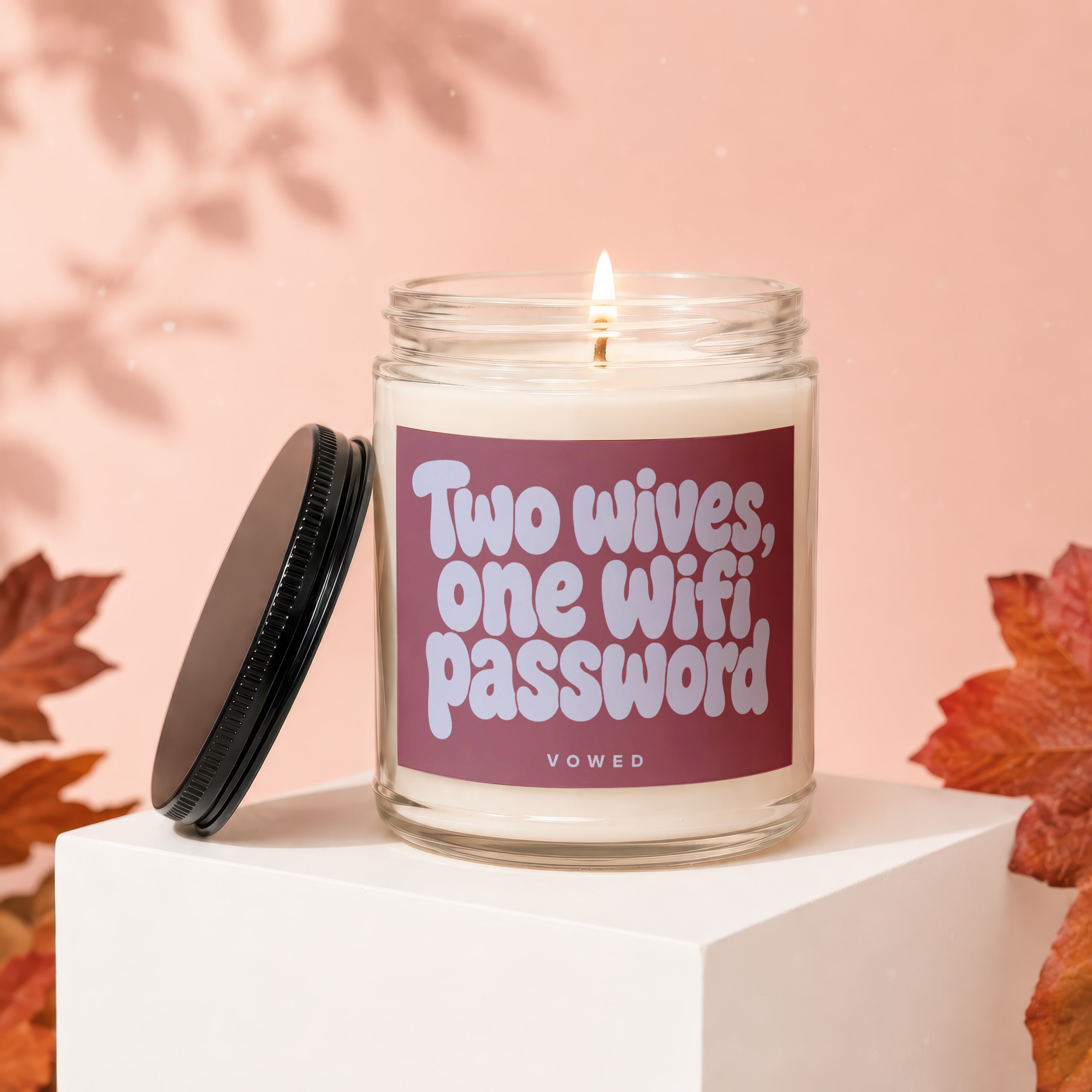 Glass jar candle with text "Two wives, one wifi password."