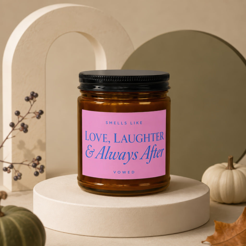 Amber candle with pink label reading "Smells Like Love, Laughter & Always After."