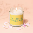 Lit candle with yellow label saying "TWO GROOMS, ONE GREAT STORY" and "VOWED".