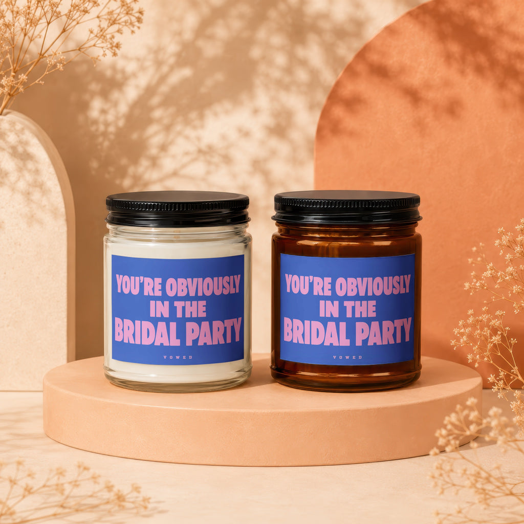 Two candles with blue labels reading "YOU'RE OBVIOUSLY IN THE BRIDAL PARTY".