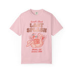 Pink t-shirt with "Sarah's Last Splash" graphic featuring flamingo float and tropical drink.