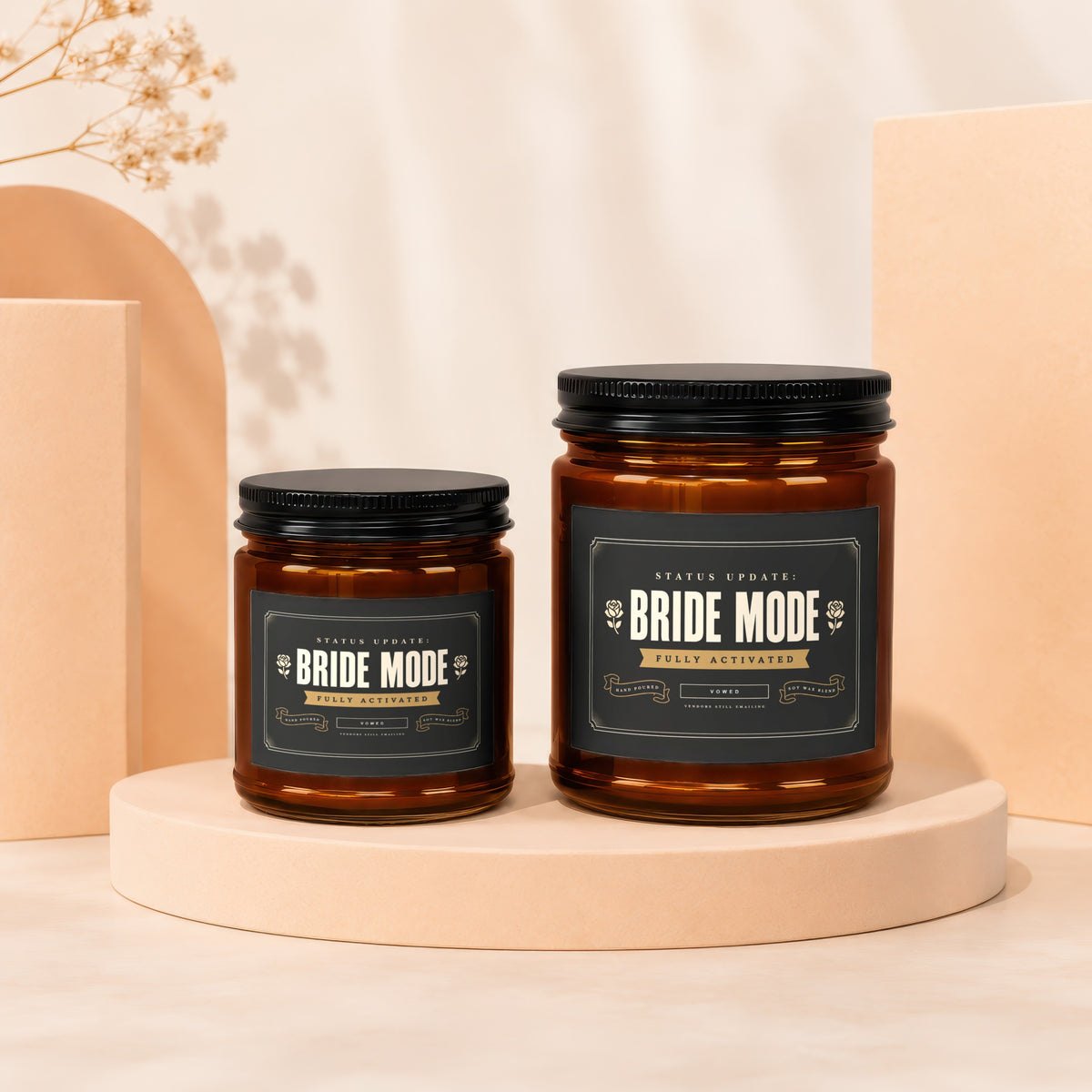 Two amber glass candles with black lids and "Bride Mode" labels on a light-colored surface.