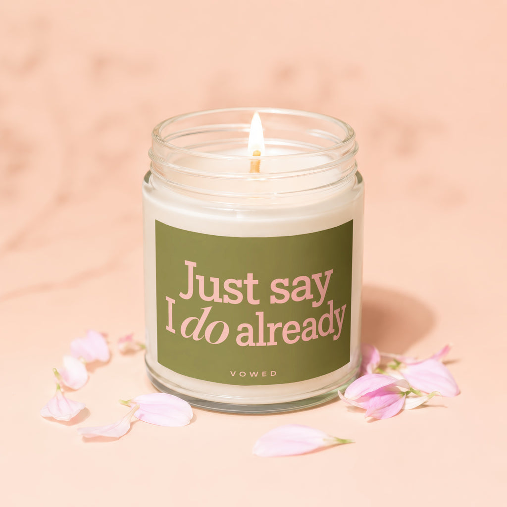 Lit candle in jar with green label reading "Just say I do already" and "VOWED".