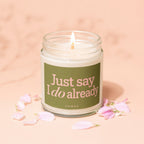 Lit candle in jar with green label reading "Just say I do already" and "VOWED".