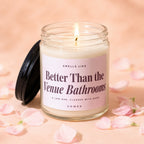 Vowed candle, "Better Than the Venue Bathrooms" scent, on a pink background with petals.