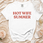 White t-shirt with red text "HOT WIFE SUMMER" styled with pearls and sandals.