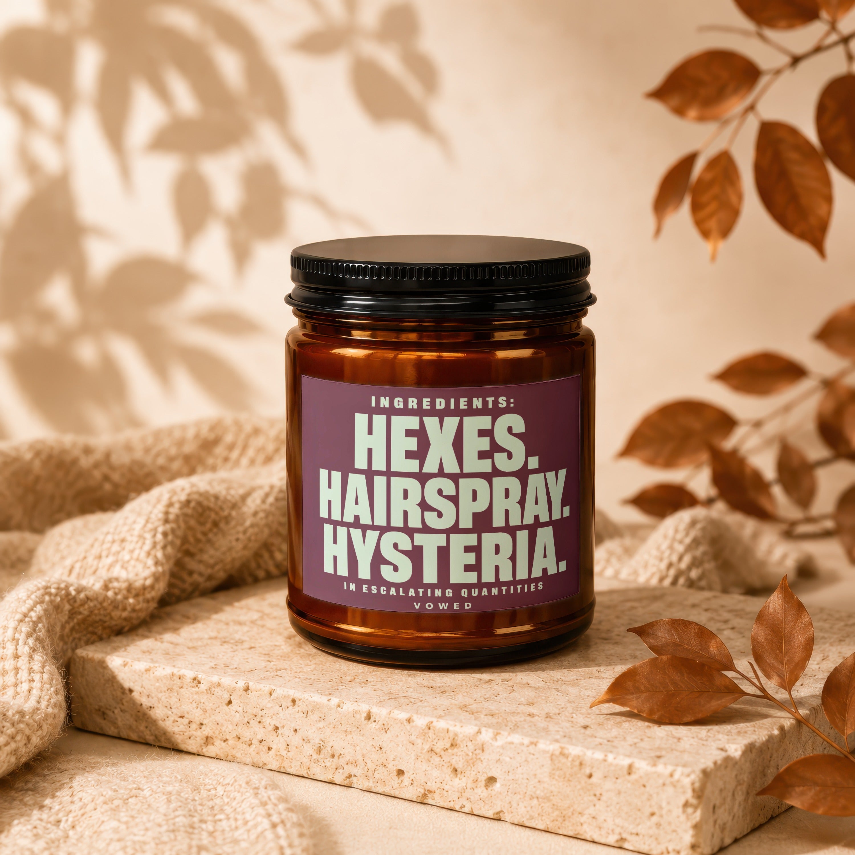 Brown glass jar with dark lid labeled "Hexes. Hairspray. Hysteria."