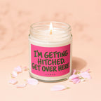 Lit candle with pink label reading "I'M GETTING HITCHED. GET OVER HERE."