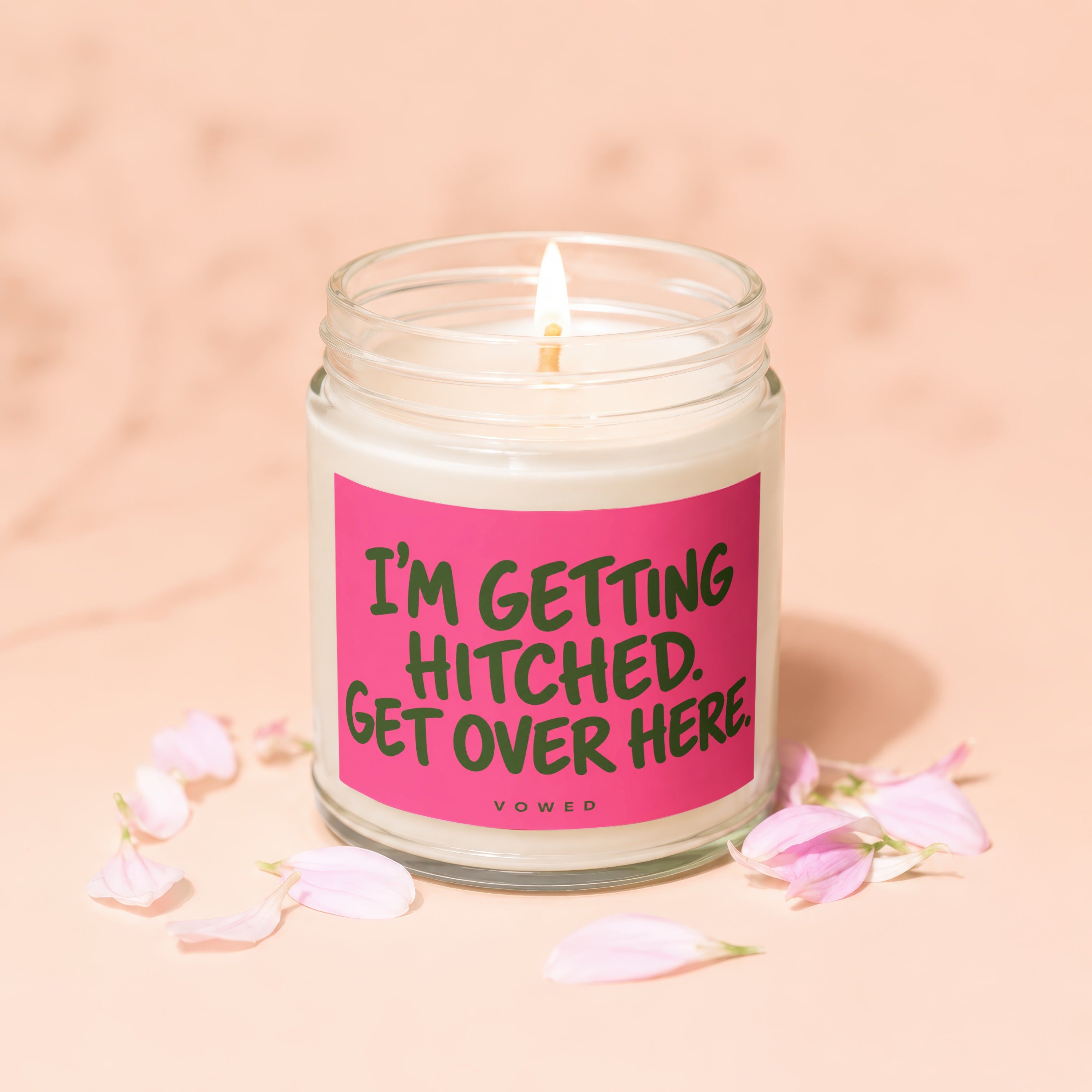 Lit candle with pink label reading "I'M GETTING HITCHED. GET OVER HERE."