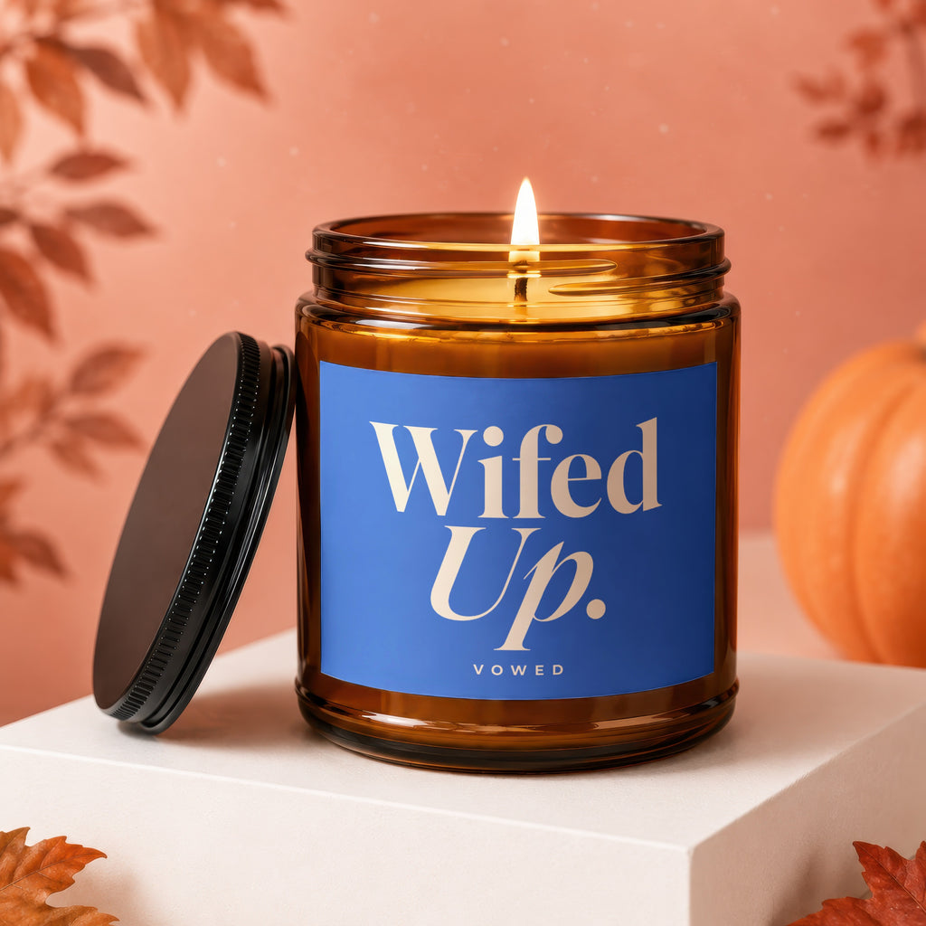 Amber jar candle with blue label reading "Wifed Up. VOWED."