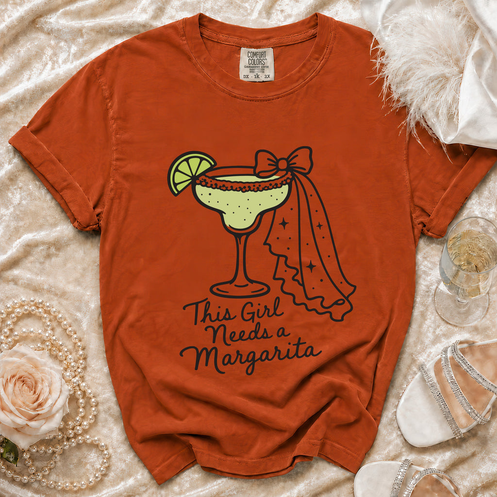 Orange t-shirt with "This Girl Needs a Margarita" and margarita graphic.