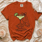Orange t-shirt with "This Girl Needs a Margarita" and margarita graphic.