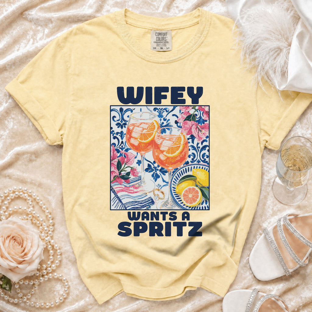 Yellow t-shirt with "WIFEY WANTS A SPRITZ" text and a graphic of two spritz cocktails.