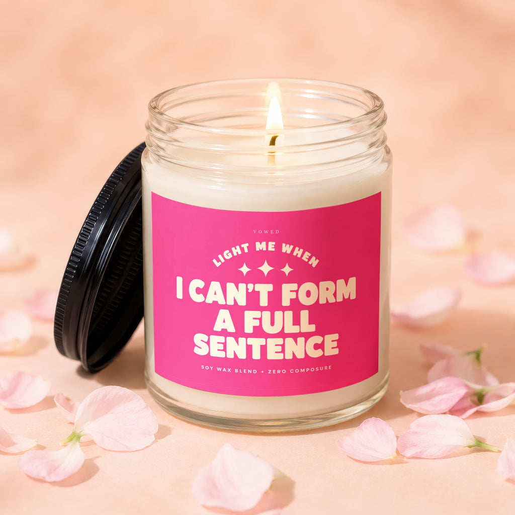 Candle with pink label that reads "Light me when I can't form a full sentence."