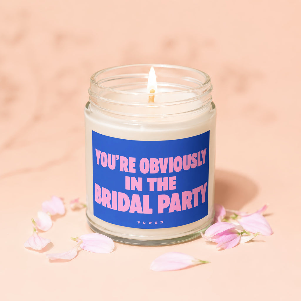 Scented candle with text "YOU'RE OBVIOUSLY IN THE BRIDAL PARTY" and "VOWED".