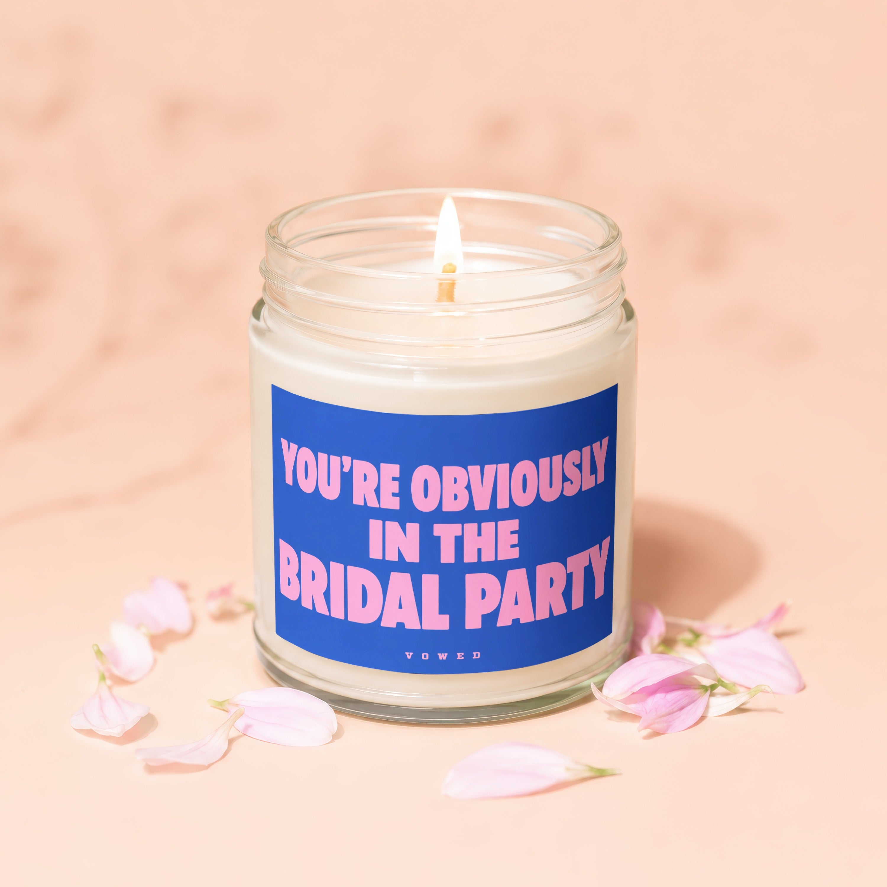 Scented candle with text "YOU'RE OBVIOUSLY IN THE BRIDAL PARTY" and "VOWED".