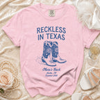 Pink t-shirt with "Reckless in Texas" and disco cowboy boots graphic.