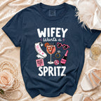 Navy t-shirt with "Wifey Wants a Spritz" graphic and bridal party icons.