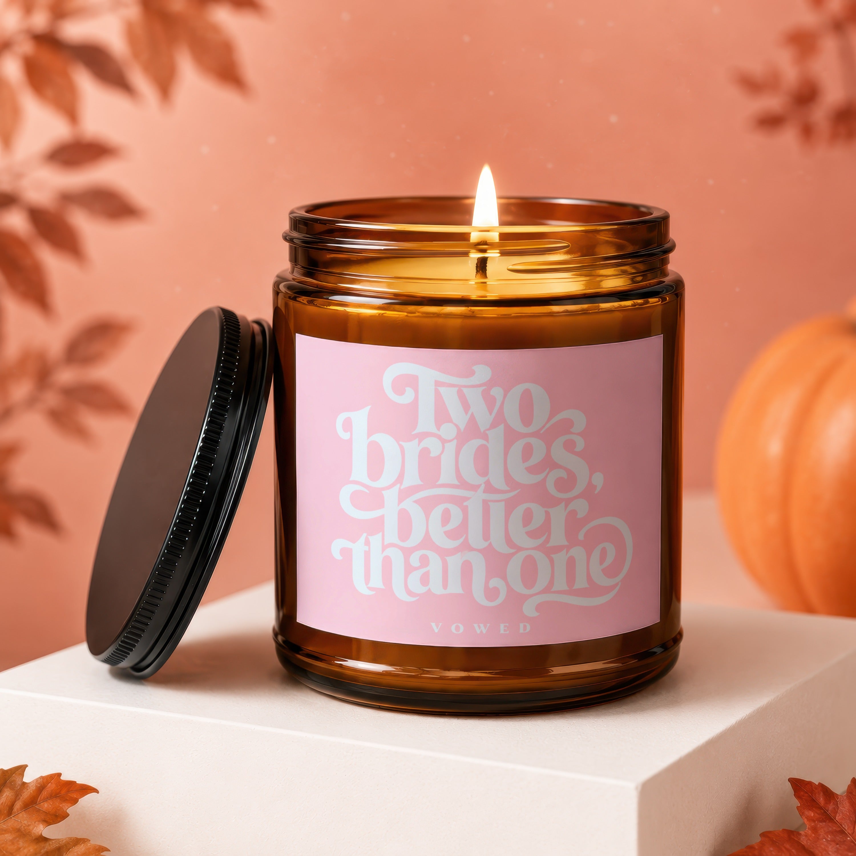 Amber candle with pink label reading "Two brides, better than one."