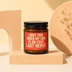 Amber candle with black lid and red label reading "Light This When My Son Is On Your Last Nerve".
