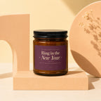 Brown glass candle labeled "Ring in the New Year. May it be your happiest yet."