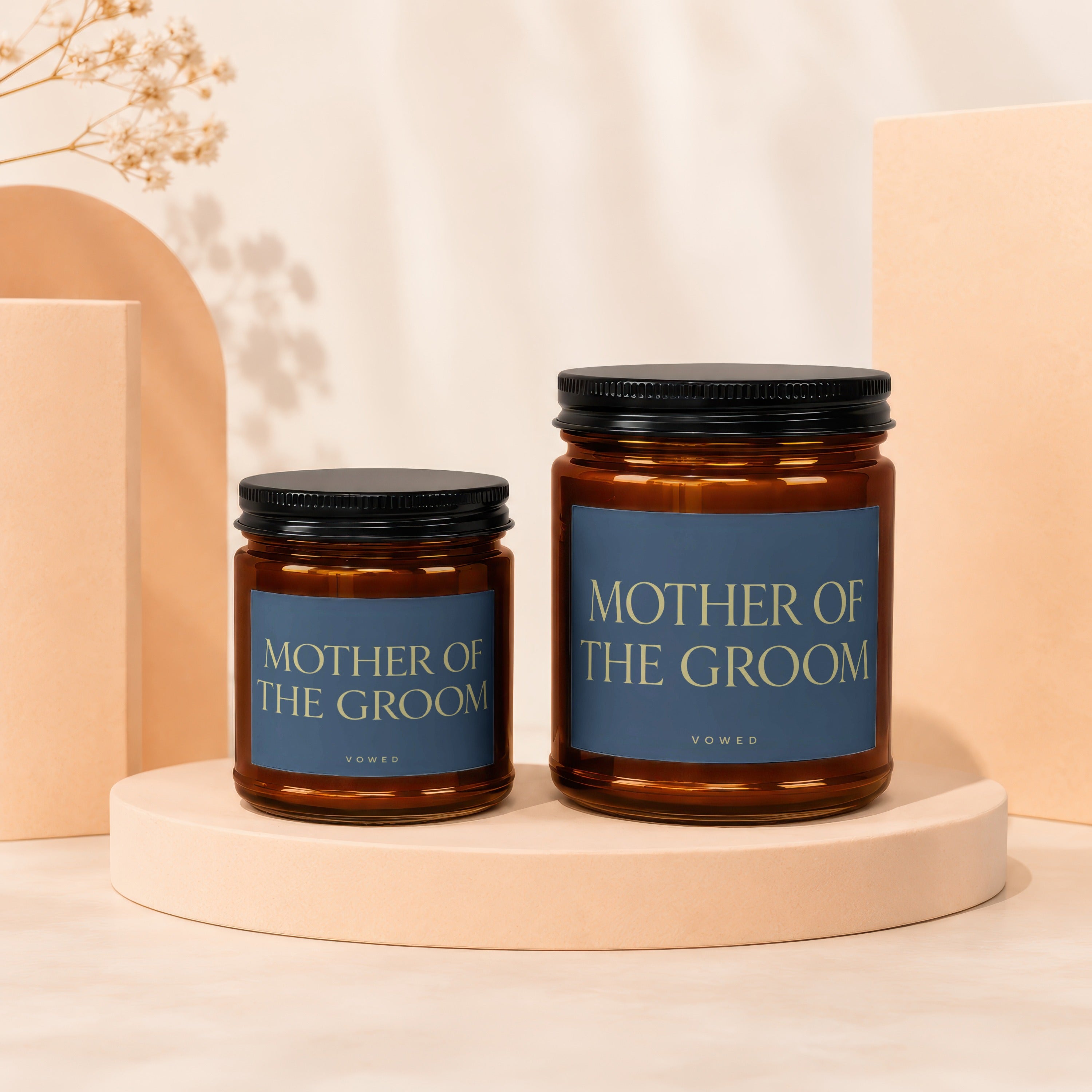 Two amber jar candles labeled "MOTHER OF THE GROOM" and "VOWED".