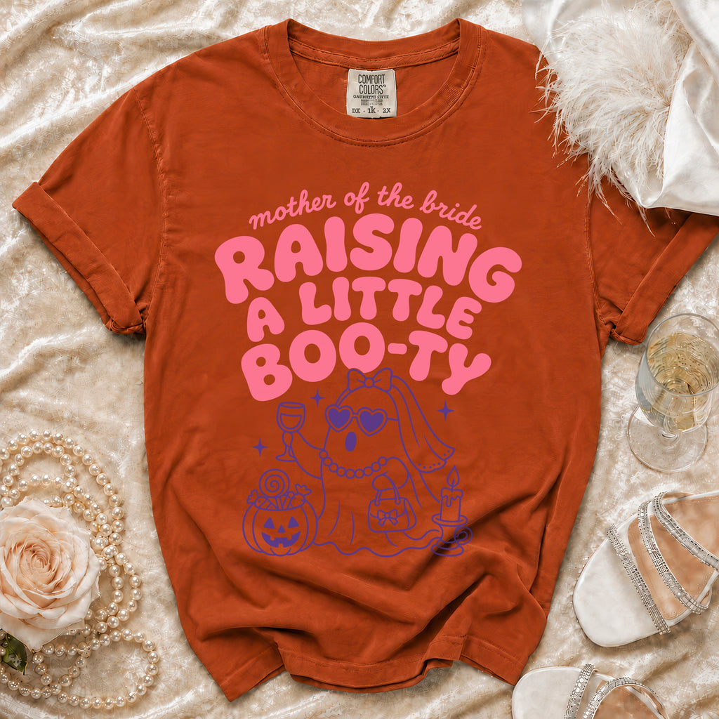 Orange t-shirt with "Mother of the Bride Raising a Little Boo-Ty" text and ghost graphic.