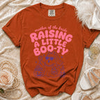 Orange t-shirt with "Mother of the Bride Raising a Little Boo-Ty" text and ghost graphic.