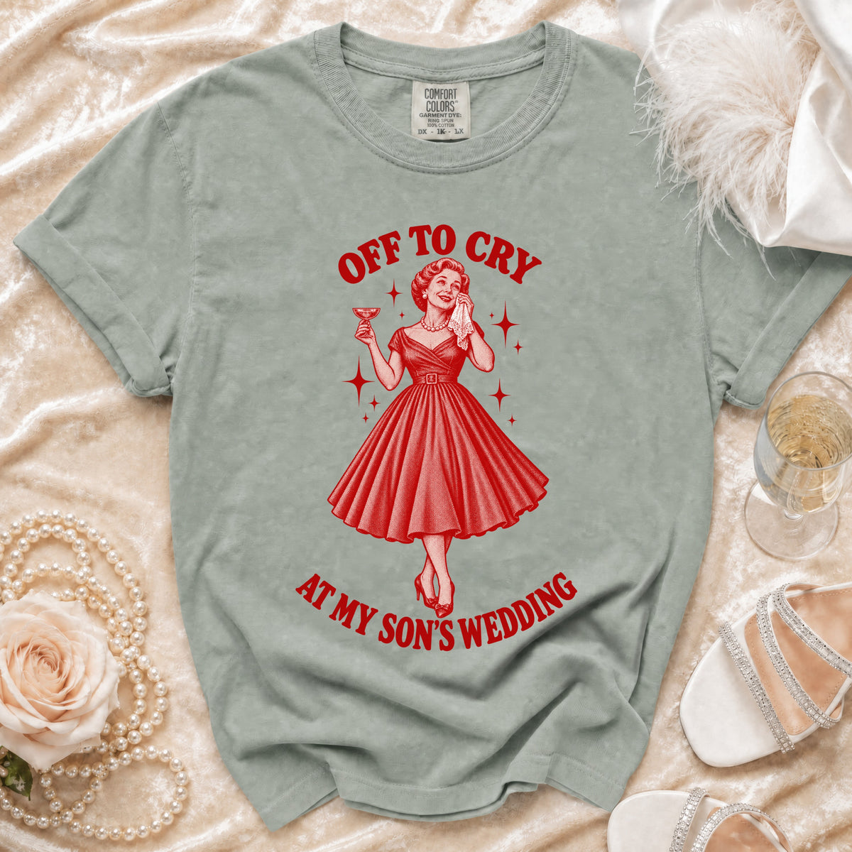 T-shirt with "Off to Cry at My Son's Wedding" graphic and a woman holding a drink.