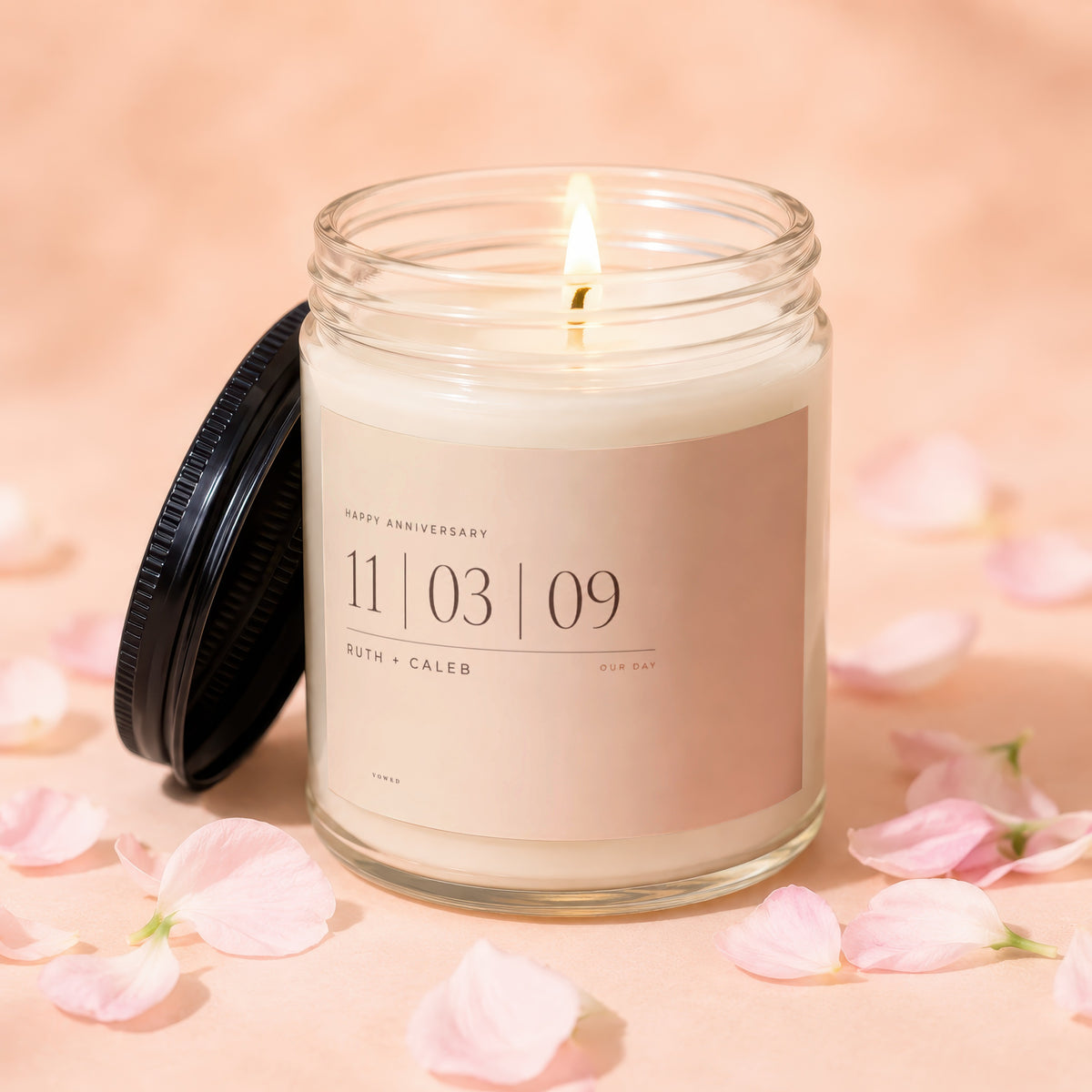 Anniversary candle with "11|03|09 RUTH + CALEB OUR DAY" text.
