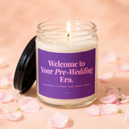 Lit candle with purple label reading "Welcome to Your Pre-Wedding Era. Showers, Fittings and Happy Tears."