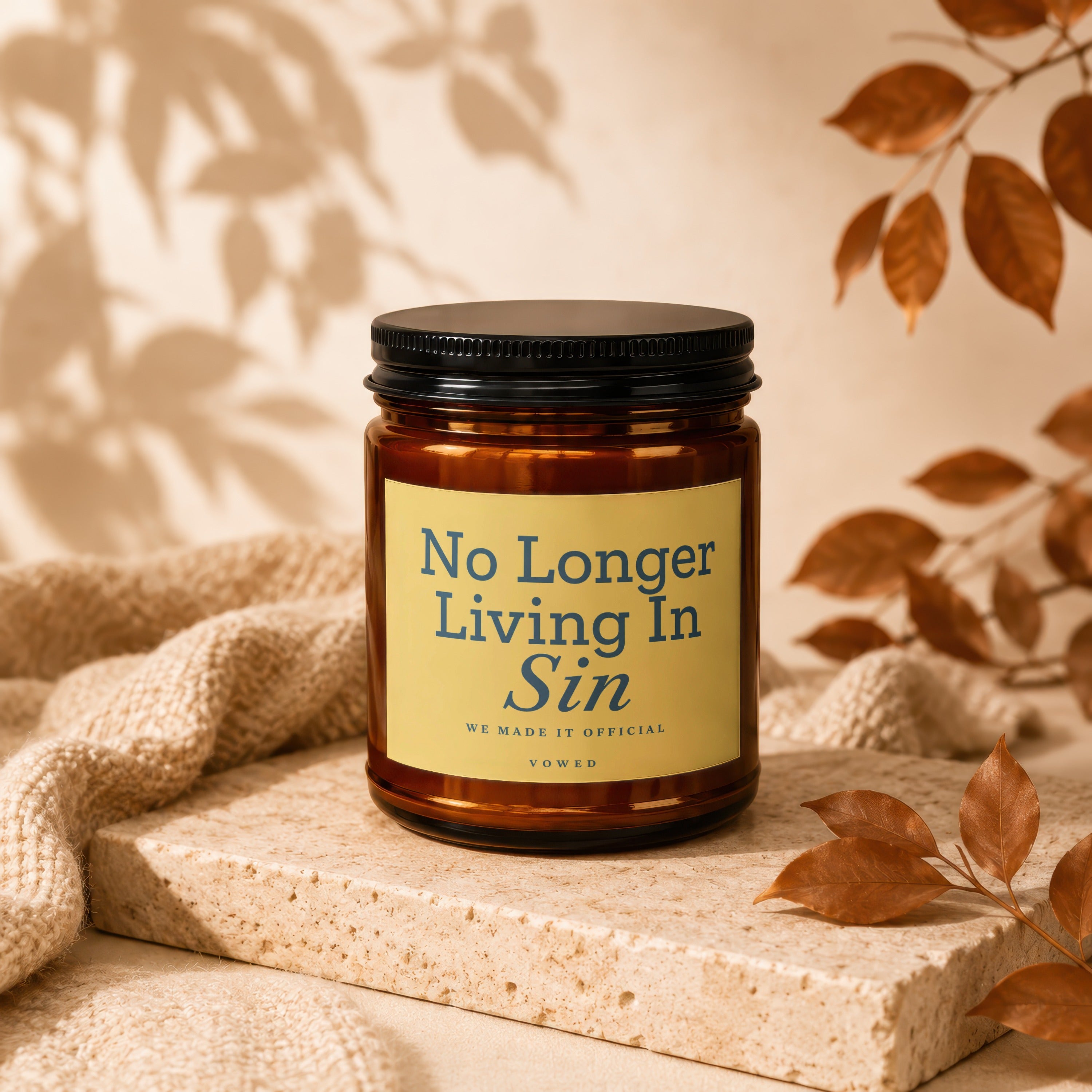 Amber candle with black lid, label reads "No Longer Living In Sin".